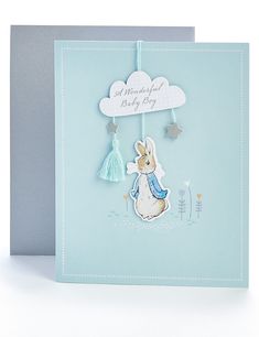 a blue card with a white rabbit hanging from it's side and the words, wonderful baby boy