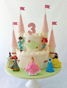 a birthday cake with princess figures on it