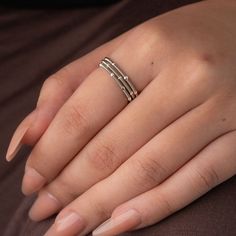 a woman's hand with two rings on it