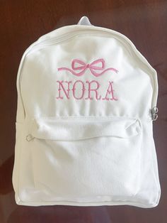 Baby Girl's First Bookbag! Name and thread color are customizable. White canvas book bag. White Softback Canvas Bag For School, White Softback Canvas School Bag, Cute Canvas Bag For Back To School, White Canvas Backpack For Back To School, Cute Canvas School Bag, Preppy White Bag For Back To School, Preppy White Bags For Back To School, Preppy White Bags For School, Preppy White School Bag