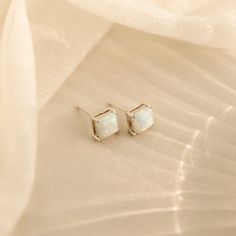 Introducing our Princess Cut Opal Studs, a vintage-inspired touch of elegance for your everyday look. With their classic princess cuts and enchanting opal stones, these earrings effortlessly add a hint of timeless charm to any outfit, making them perfect for both casual and special occasions. Material: High Quality Solid 925 Sterling Silver Finish: Sterling Silver ∙ 18K Gold Featuring elegant ~7x7mm square CZ Opal Stud Earrings Sold as a Pair Part of our Opal Collection Model showcases a chic ev Classic White Birthstone Earrings, Dainty Opal Earrings For Wedding, Opal Earrings For Wedding, Dainty White Opal Earrings, Classic Opal Jewelry For Formal Occasions, Elegant Hypoallergenic Opal Jewelry, Initial Tag Necklace, Sideways Initial Necklace, Dainty Initial Necklace