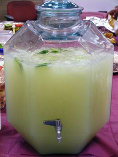 a large pitcher filled with liquid sitting on top of a table