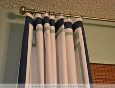 blue and white striped curtains hanging on the wall