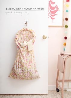 a dress hanging on the wall next to a chair