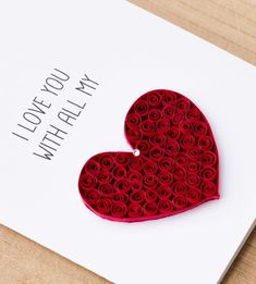 a card with a heart made out of rolled paper