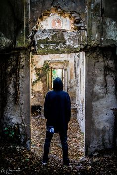 a person standing in an abandoned building