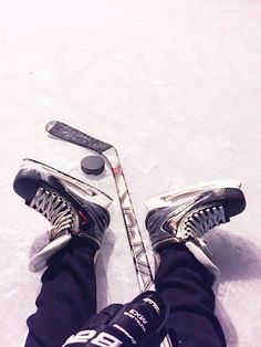 the legs and feet of a person on skis in the snow with poles attached to them