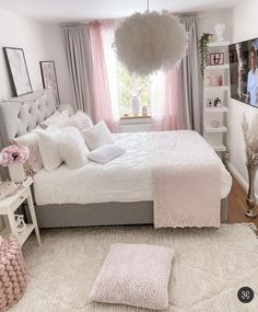 a bedroom with pink and white decor in it