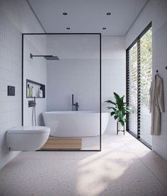 a bathroom with a large white bathtub next to a toilet