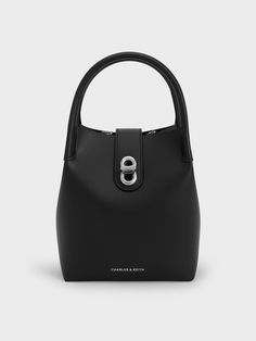 This product is made with at least 20% sustainable materials by weight. CHARLES & KEITH uses recycled, degradable, organic, and water-based materials in our eco-conscious collection. For the minimalists, the Aubrielle bag is the perfect everyday bag. The clean, unembellished exterior lets the structured silhouette stand out, especially when it comes in sleek inky black. For a contrasting element, the silver-toned turn-lock closure adds just a touch of shine. With its capacious interior and ... The Minimalists, Ikat Pinggang, Brand Collaboration, Size Chart For Kids, Charts For Kids, Buckled Heels, Consumer Protection, Marc Jacobs Bag, Charles Keith