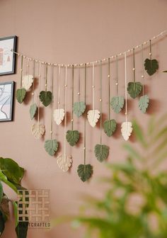 there is a wall hanging with leaves on it