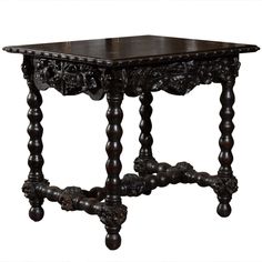 an ornate wooden table with carved legs