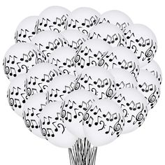 a bunch of white balloons with musical notes on them