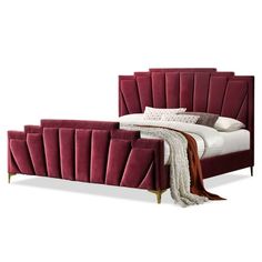 a bed with a red velvet headboard and foot board on top of the bed