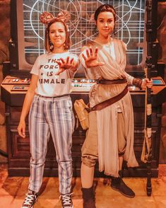 two women standing next to each other in front of a tv