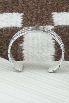 This sterling silver bracelet was made by Navajo silversmith Elvira Bill. The bracelet is signed Elvira Bill and stamped sterling.Size: 5 1/4" (will fit up to a 6 3/8" wrist)Gap: 1 1/8"Width: 1 1/2"Free shipping on all orders! We ship with USPS and always include tracking. All orders ship within a day of payment.Returns are accepted up to 30 days after you receive your order. Just send us a message. Our shop offers cash back or store credit. The item must be returned in new condition. Southwestern Silver Bracelet Jewelry, Southwestern Style Silver Bracelet Jewelry, Southwestern Style Silver Bracelet, Western Style Silver Bracelets For Gift, Western Style Silver Bracelet For Gift, Western Style Silver Bracelet Jewelry, Western Style Silver Bracelet, Southwestern Sterling Silver Cuff Bracelet In Silver, Western Style Silver Engraved Bracelets