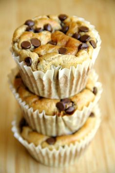 three cupcakes stacked on top of each other with chocolate chips in the middle