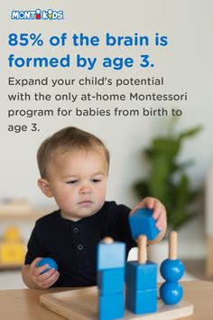 a baby sitting at a table playing with wooden blocks and building toys in front of a sign that says 85 % of the brain is formed by age 3