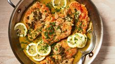 chicken with lemons and herbs in a pan