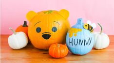 three pumpkins with winnie the pooh faces on them