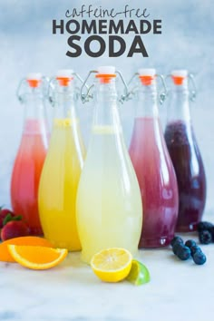 homemade sodas in glass bottles lined up with fruit and berries on the side, text overlay reads caffeine - free homemade soda