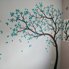 a bathroom with a tree painted on the wall