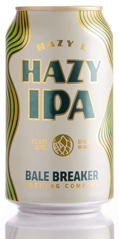 a can of hazy iba beer on a white surface with reflections in the water