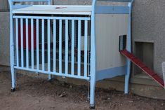 a baby crib next to a building with a red ramp