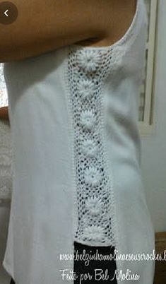 a woman is wearing a white dress with crocheted trim