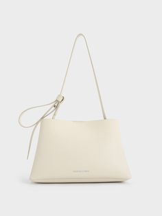 This product is made with at least 20% sustainable materials by weight. CHARLES & KEITH uses recycled, degradable, organic, and water-based materials in our eco-conscious collection.If you are looking for a bag that can add a distinctive touch to any look, this Odella bucket bag tick all the boxes. It features a striking trapeze silhouette that is semi-slouchy in construction -- the minimalist design lets the unconventional shape be the star of the show. It also comes with a magnetic closure tha Modern Everyday Recyclable Bags, Modern Recyclable Bags For Everyday Use, Modern Rectangular Recyclable Bag, Modern Recyclable Shoulder Bag For Shopping, Modern Recyclable Tote Bag, Recyclable Double Handle Shoulder Bag For Daily Use, Eco-friendly Cream Shoulder Bag With Removable Pouch, Beige Recyclable Tote Shoulder Bag, Eco-friendly Tote Shoulder Bag For Everyday