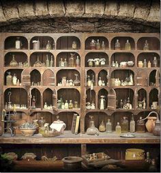 an old wooden shelf filled with lots of bottles