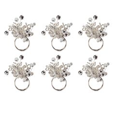 four silver rings with pearls and beads on each one side, in the shape of flowers