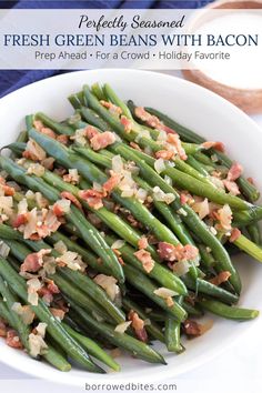 a white bowl filled with green beans covered in bacon