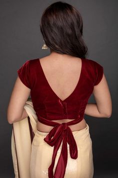 As immersive as your dreams, this velvet textured partywear blouse in Burgundy/Deep red Depending on the lighting is everything that you could ever wish for. The blouse has a back closure with a Wraparound tie and can be customized for color and sleeves. Blouse Color : Burgundy (Deep Red) Blouse Fabric : Velvet Blouse Design: As seen - Front and back V neck with waist Tie and Cap SleevesCustom Options: Customizable Sleeves, neckline not customizable Closure: Back Work : Solid Occasion : Party Di Blouse Designs Latest For Velvet, Red Velvet Saree Blouse, Back V Design Blouse, Maroon Velvet Blouse Saree, Bilauj Design Back, Blouse Designs Velvet Style, Velvet Blouses Designs, Welwet Blouse Designs Latest, Back Tying Blouse Designs