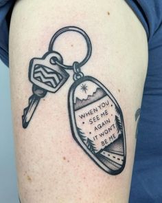 a woman with a tattoo on her arm has a keychain that says, when you see me, again it doesn't be me