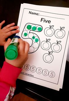 a child is writing numbers on a piece of paper