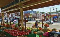 an outdoor farmers market with lots of fresh produce