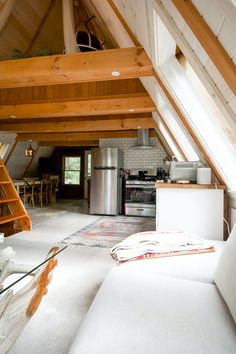 a loft with an open kitchen and living room