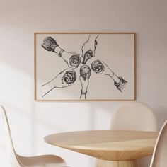 a painting hanging on the wall above a wooden table with chairs and a white chair