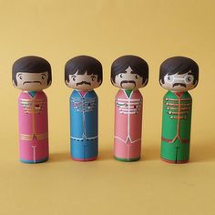 the beatles dolls are lined up in different colors