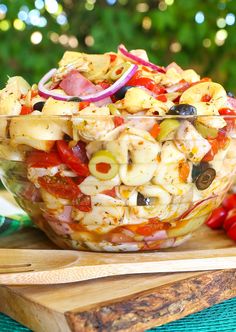 pasta salad in a glass bowl on a cutting board