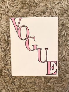 a piece of paper with the word voque on it sitting on top of carpet