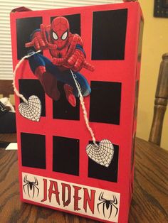 a red box with spiderman on it sitting on a table