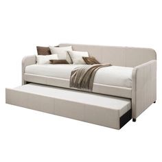 a white daybed with pillows on it and a pull out bed in the middle