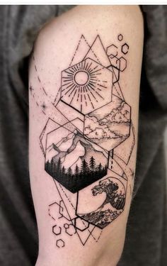 a man's arm with an image of mountains, trees and sun on it