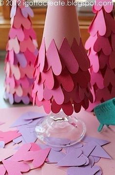 pink and purple paper trees are on the table