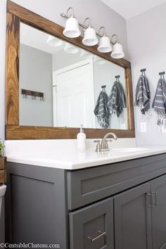 a bathroom with a sink, mirror and lights