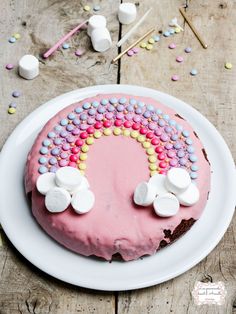 a cake decorated with candy and marshmallows on a plate