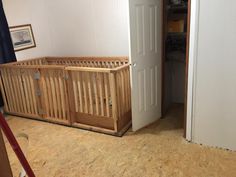 a baby crib sitting in the corner of a room next to an open door