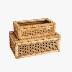 two wicker boxes sitting on top of each other